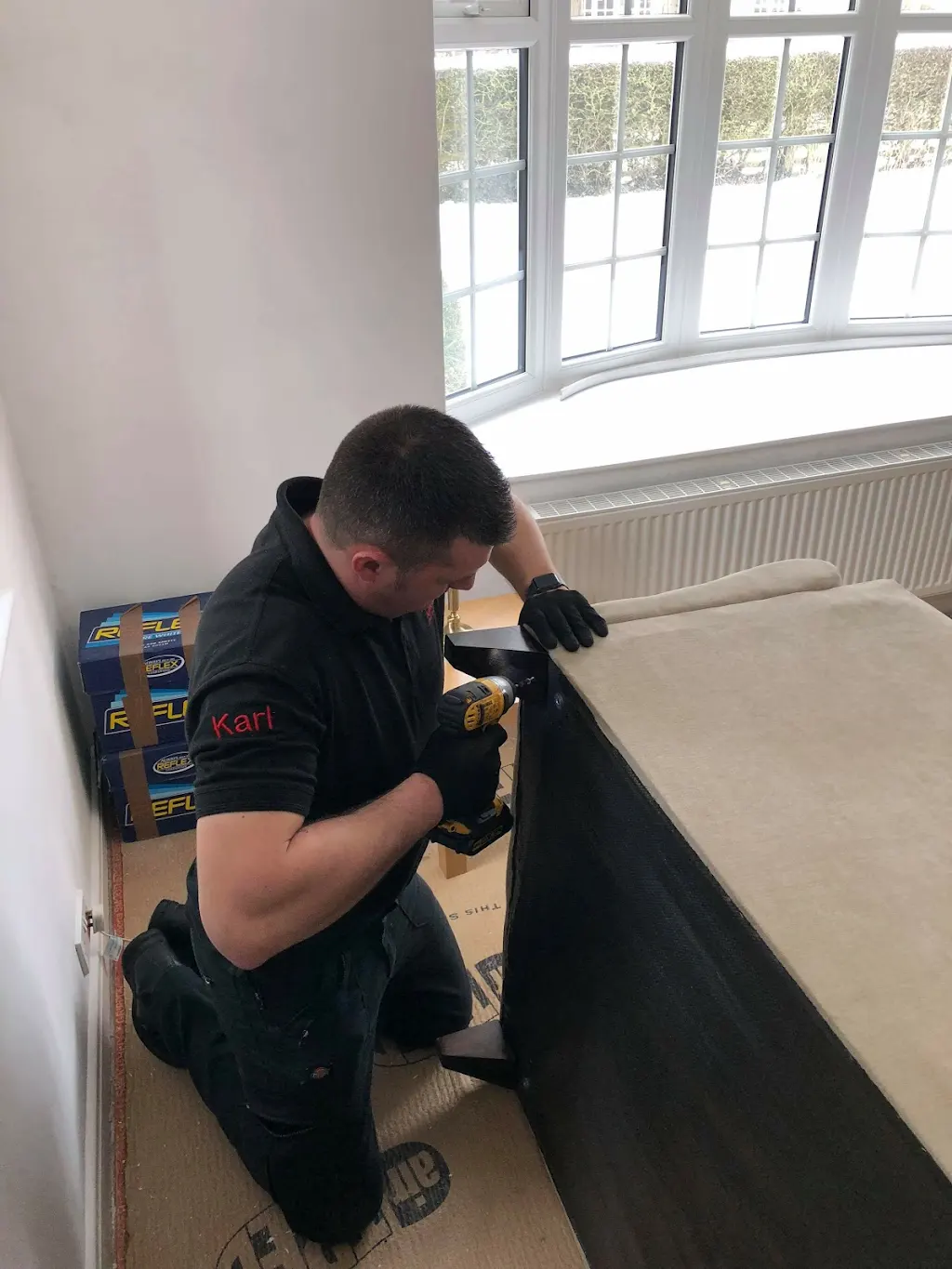 Karl dismantling and reassembling furniture